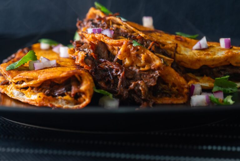 3,Beef,Birria,Tacos,Stacked,On,Black,Plate