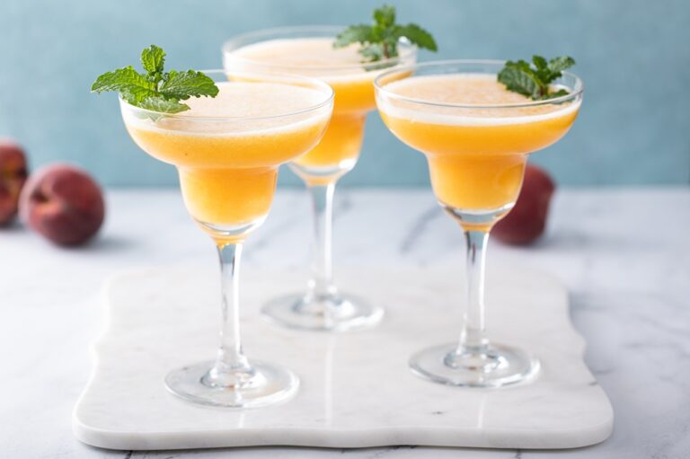 Frozen,Peach,Margaritas,In,Three,Glasses,Garnished,With,Mint