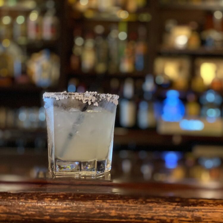Classic margarita on wooden bar top