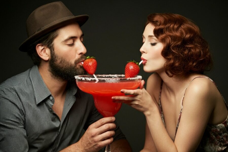 Crimson Kiss Margarita - Most Romantic Day of the Year - Couple sharing a large red margarita