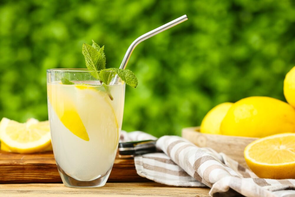 Glass,Of,Fresh,Lemonade,With,Mint,On,Wooden,Table,Outdoors
