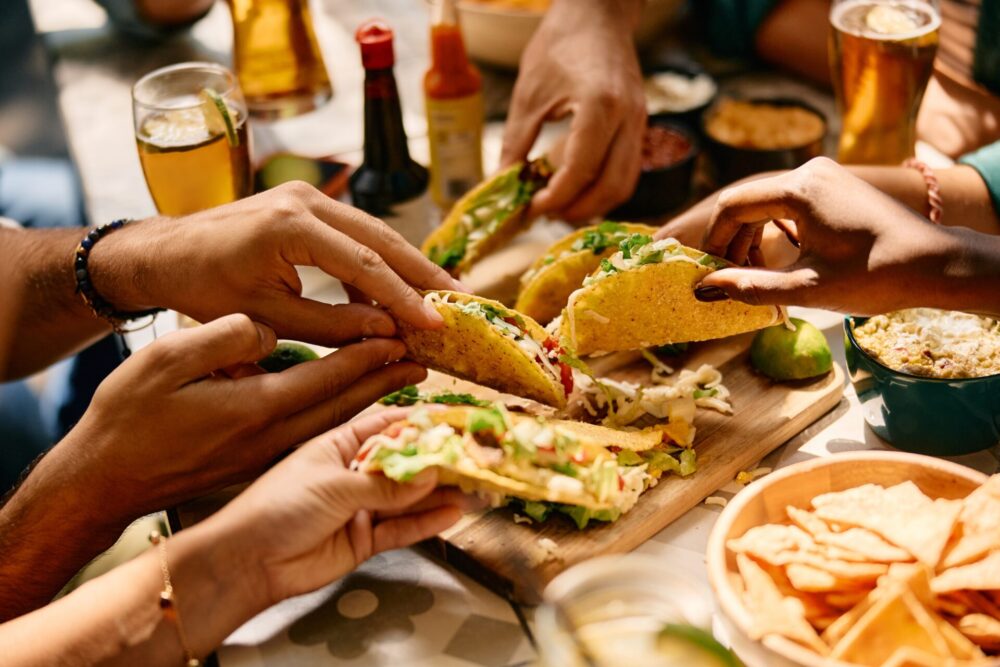 Close,Up,Of,People,Eating,Mexican,Food,In,A,Restaurant.
