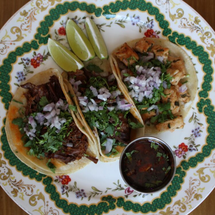 three tacos - chicken, beef and pork with sauce