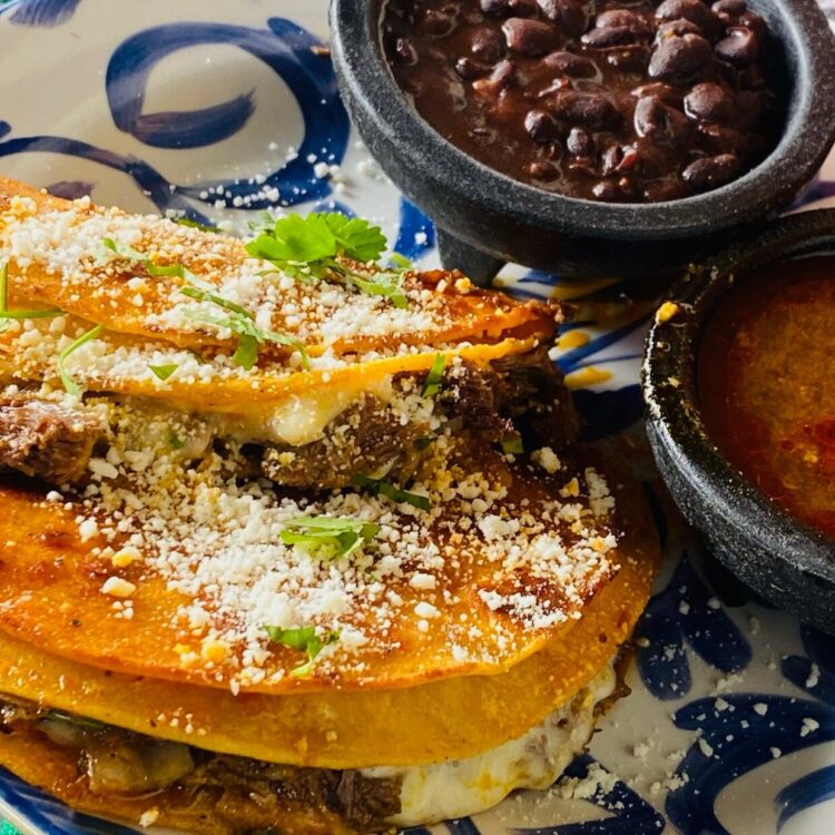 Birria Tacos with consome and side of black beans