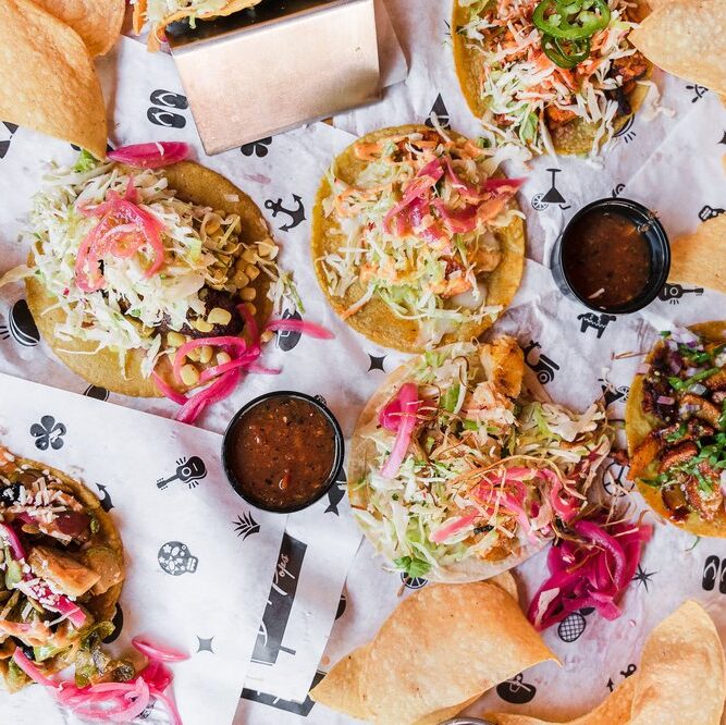Table top of tacos and tortilla chips