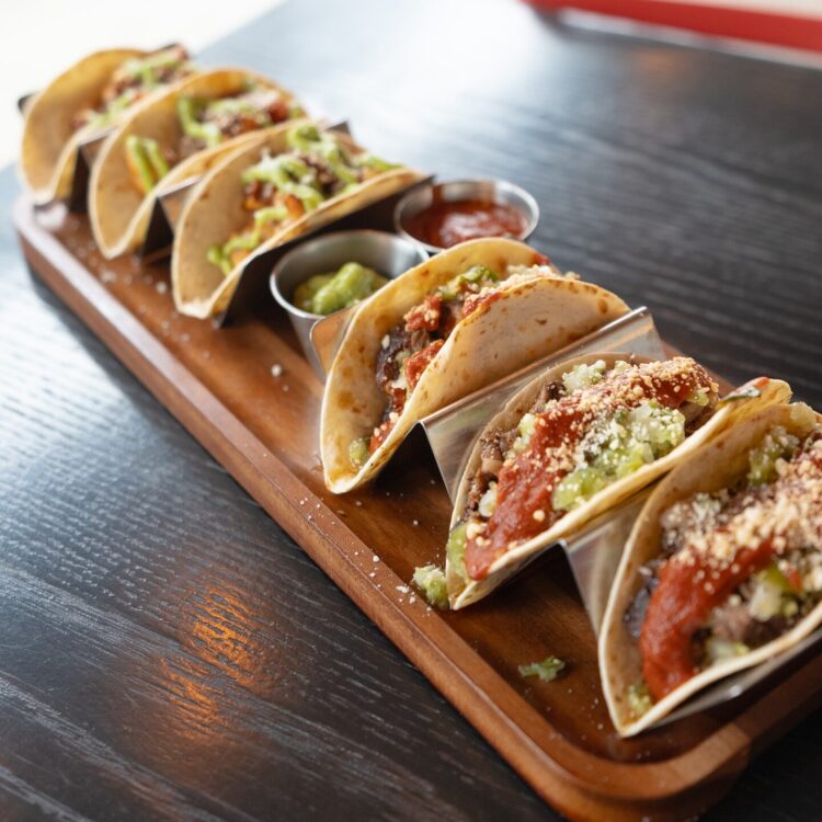 Taco Board with 6 tacos and 2 sauces