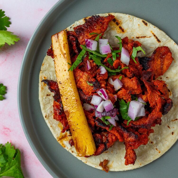 Taco al Pastor on grey round plate