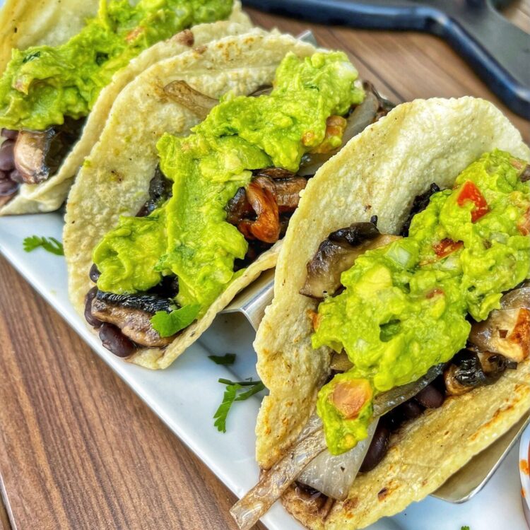 3 Veggie tacos topped with guacamole