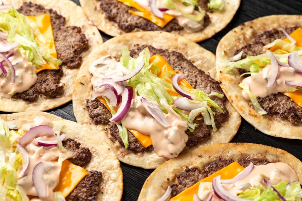 HomemadeTacoSmashBurgerWithSauceCheeseLettuceAndRed