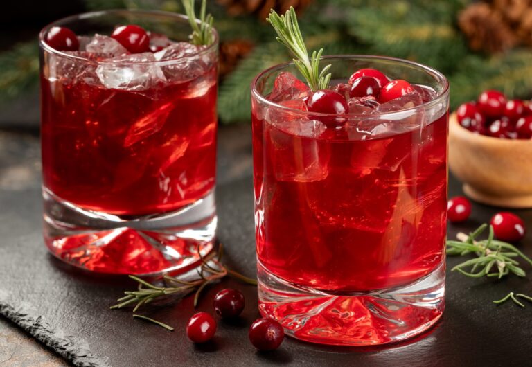 Cranberry,Cocktail,With,Fresh,Cranberries,And,Roseemary,On,Black,Slate