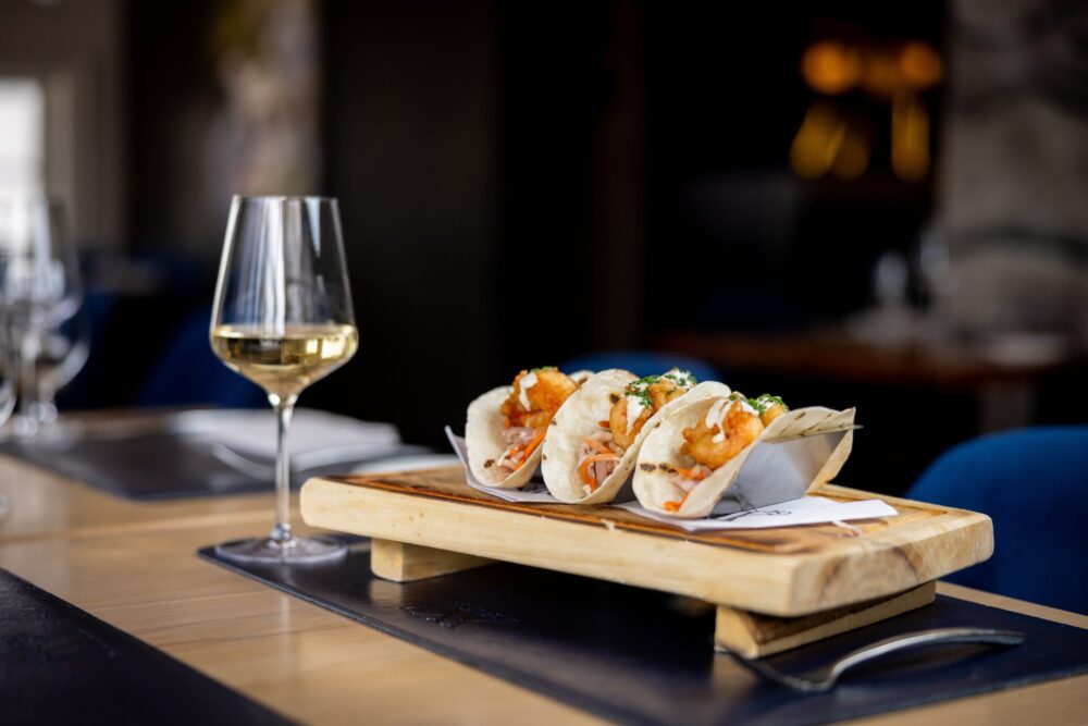 Three,Delicious,Fried,Fish,Tacos,On,Butcher,Block,And,White