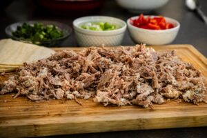 Carnitas,On,A,Cutting,Board,With,Ingredients,Like,Tomatoes,,Cilantro