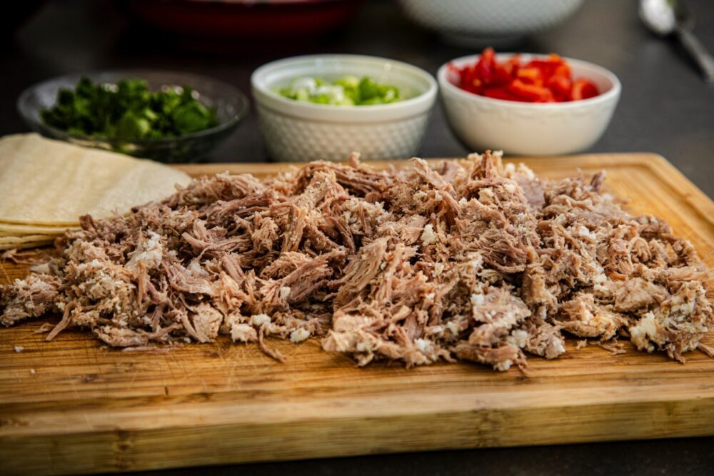 Carnitas,On,A,Cutting,Board,With,Ingredients,Like,Tomatoes,,Cilantro