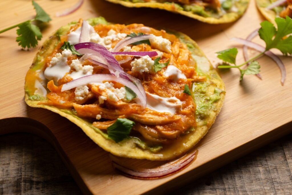 Chicken,Tinga,Tostadas,With,Cheese,And,Avocado.,Traditional,Mexican,Food