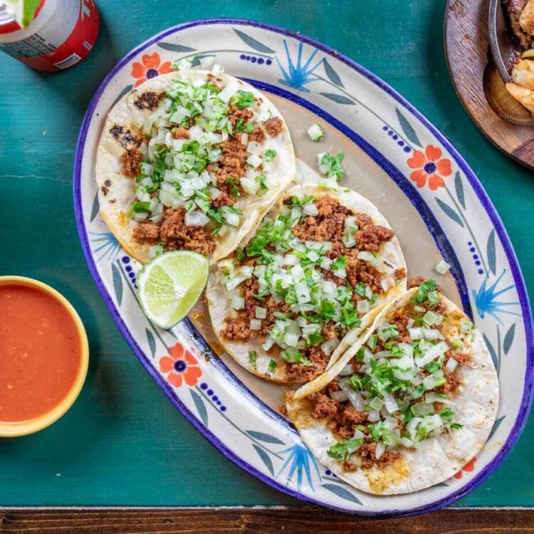 grilled steak tacos with bacon, chorizo, onions, and peppers