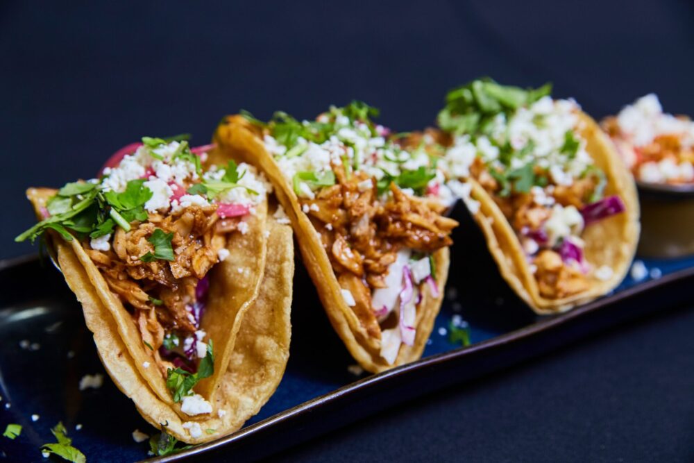 Colorful,Chicken,Tacos,On,Dark,Blue,Plate,,Eye-level,View