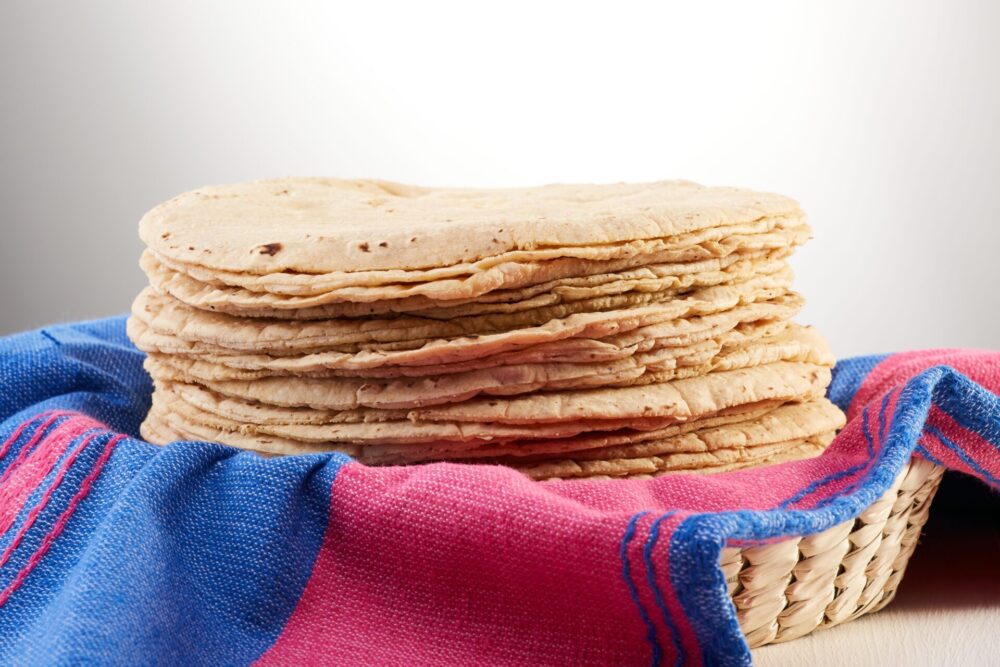 Pile,Of,Freshly,Made,Tortillas,Over,A,Mexican,Pink,And
