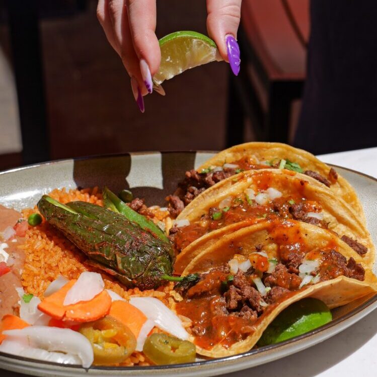 Squeezing lime onto tacos