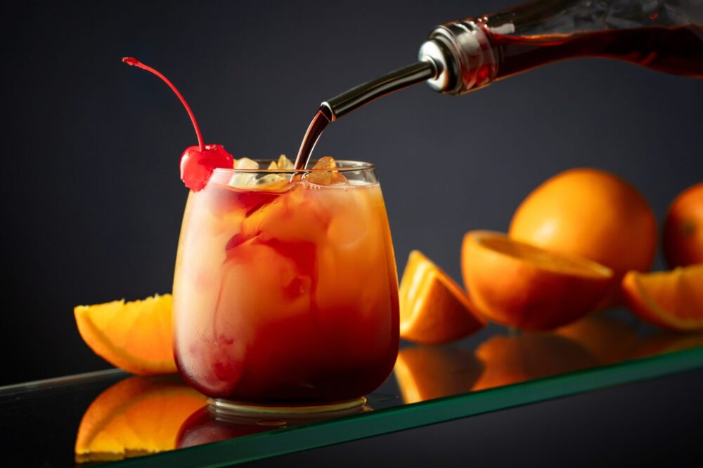 Tequila,Sunrise,Alcoholic,Cocktail,On,A,Dark,Background.,Grenadine,Is
