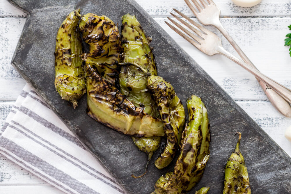 Roasted,Hatch,Chili,Peppers,On,The,Cutting,Board.,Fall,Harvest.