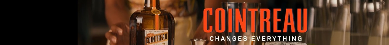 Bottle of Cointreau on a bar with the COINTREAU logo and the slogan 'CHANGES EVERYTHING' in bold red letters