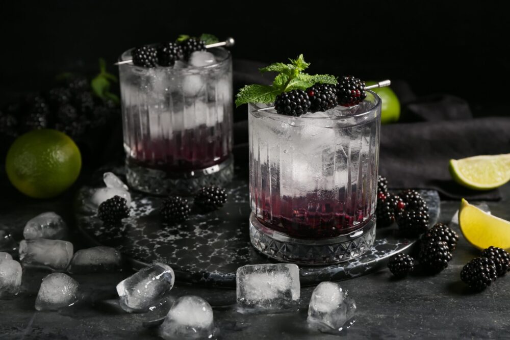 Glasses,With,Tasty,Cool,Blackberry,Lemonade,On,Black,Background,,Closeup