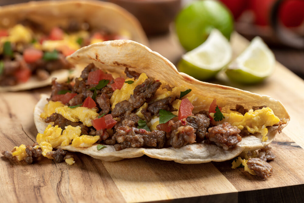 Closeup,Of,A,Breakfast,Taco,With,Scrambled,Egg,,Sausage,And