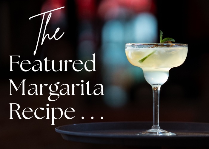 The Featured Margarita Recipe... featuring a cocktail in a welled margarita glass, blurred background