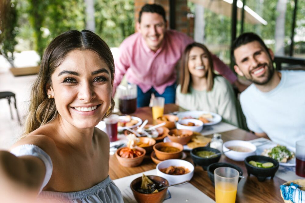 Mexican,Woman,Taking,A,Photo,Selfie,With,Group,Of,Latin